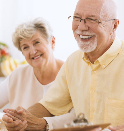 mature couple reviewing estate plan with wealth advisor
