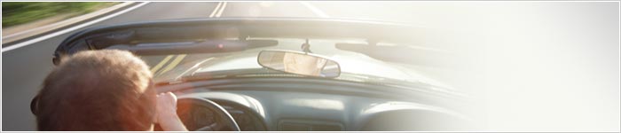picture of man driving convertible
