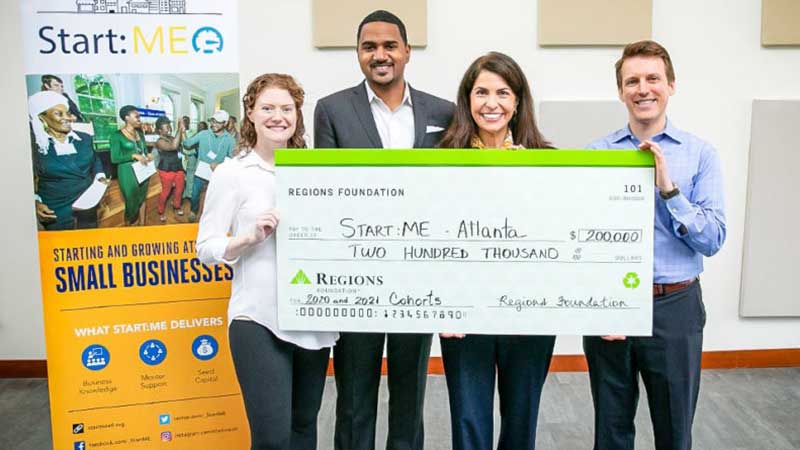 team holding a large check