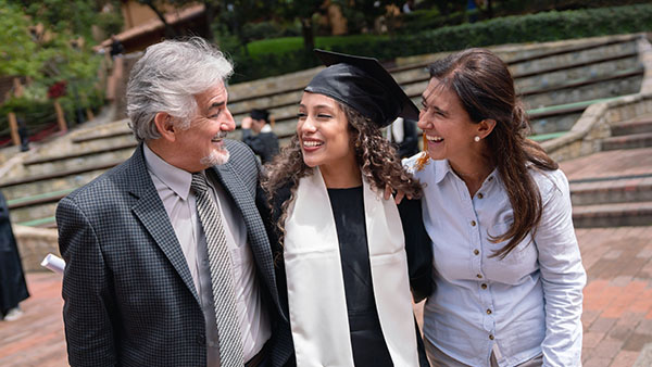 parents hugging their daughter at her graduation