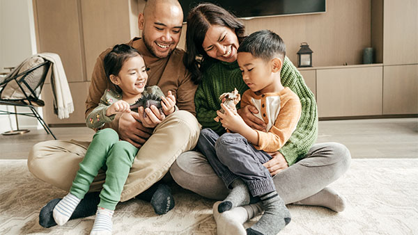 family of four sitting in the living room