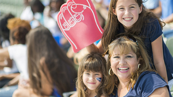 mother and two daughters at a sporting event