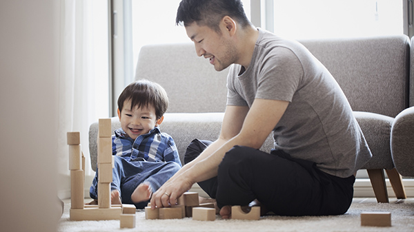 father and son playing with blocks