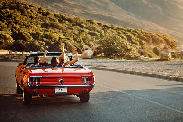 red car driving down the road