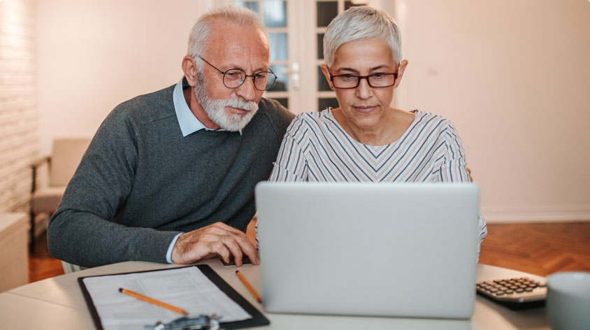 Older couple looking at laptop screen