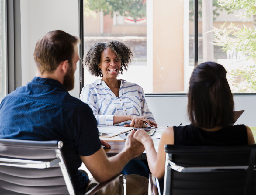 Couple talking to mortgage loan officer