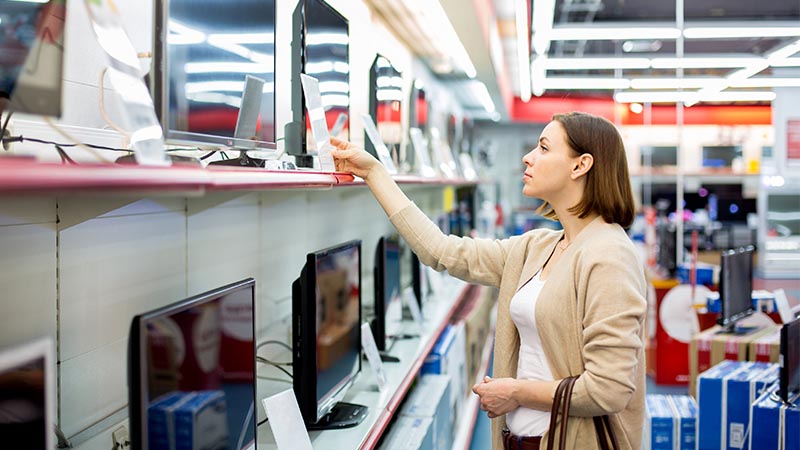 woman shopping for televisions