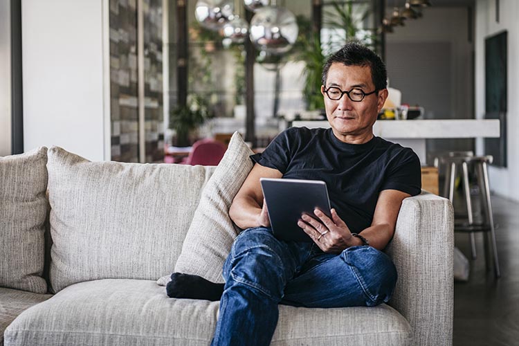 Man using a tablet on couch