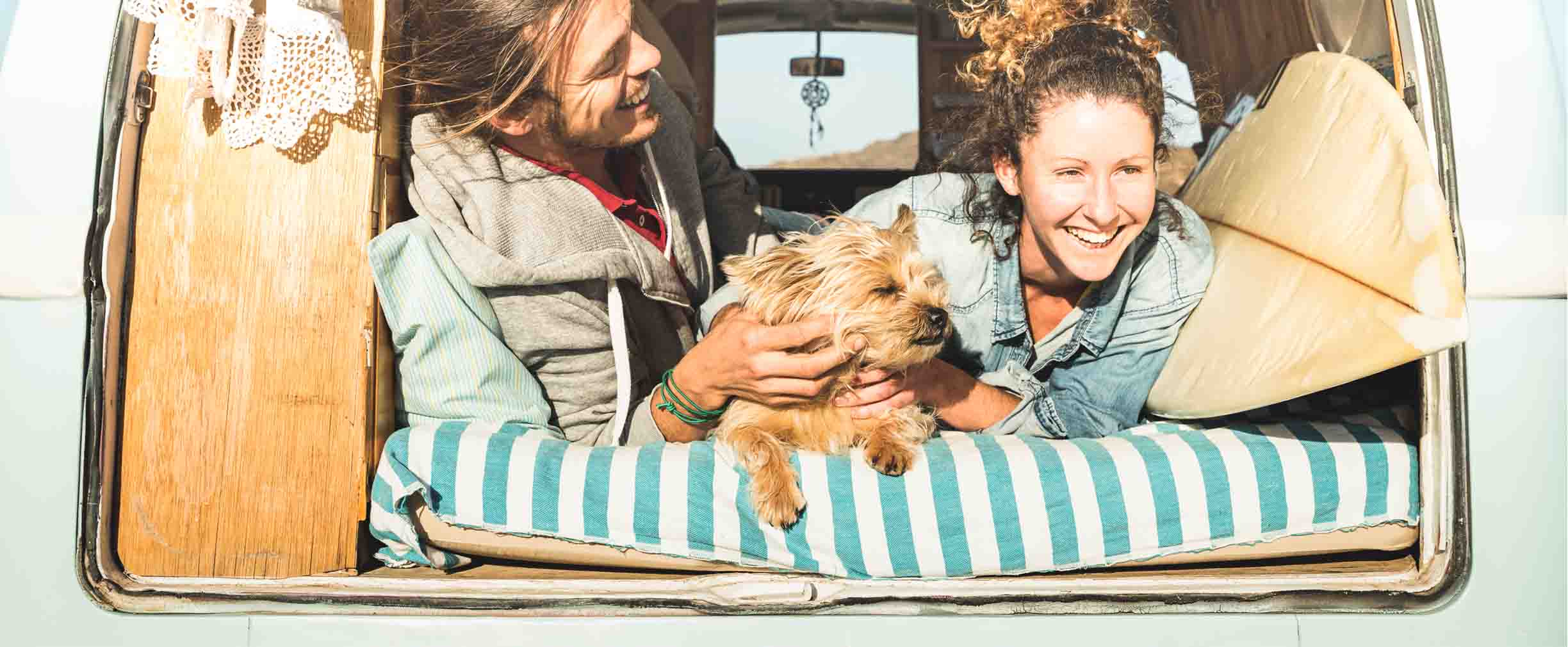 two women and a dog traveling in a van