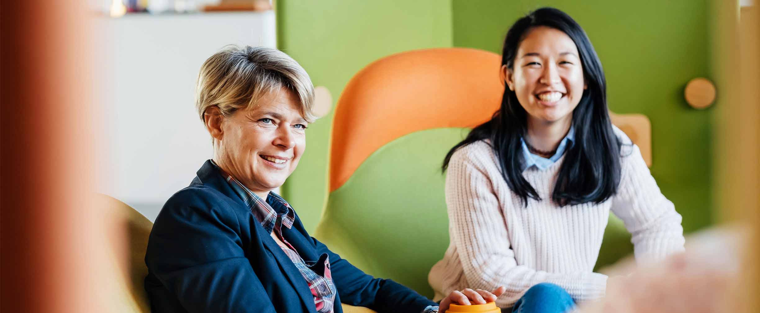 A woman and her mentor smiling.