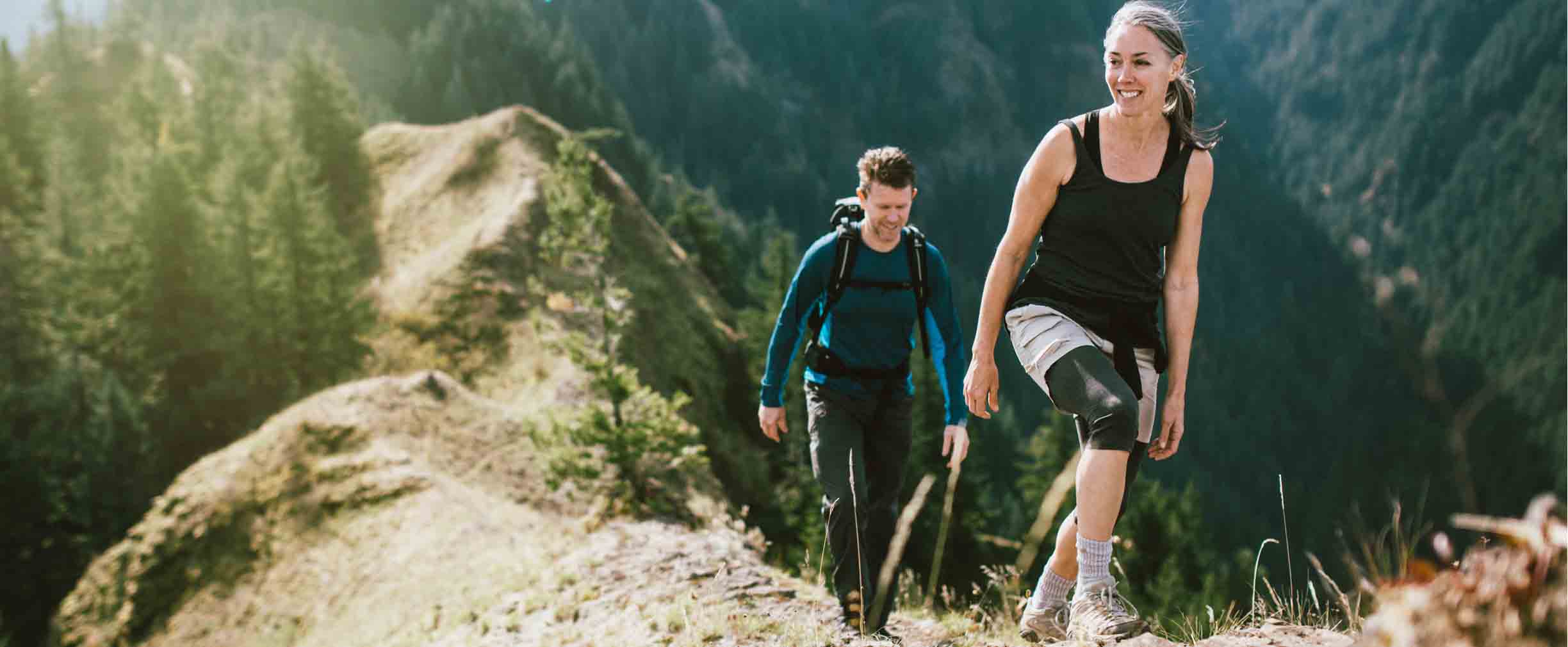 mature couple hiking a mountain