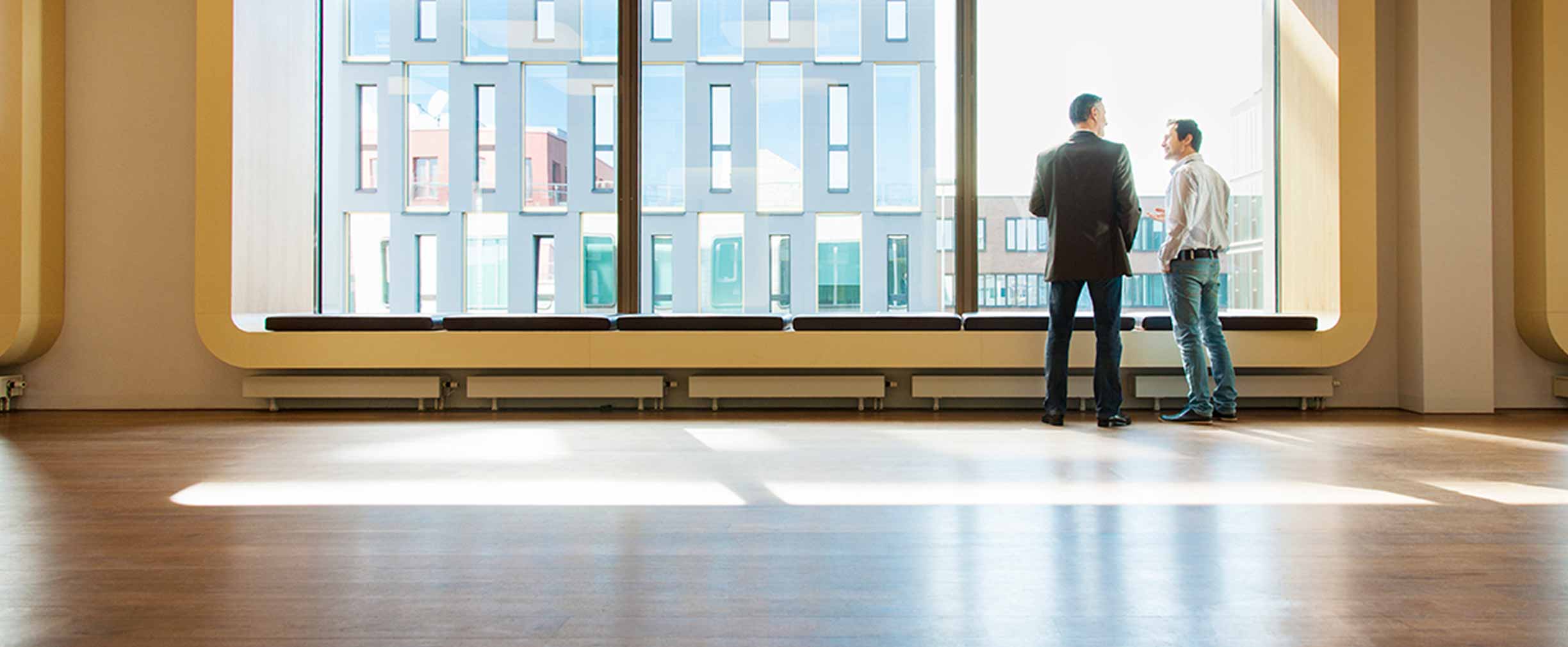 men looking out window