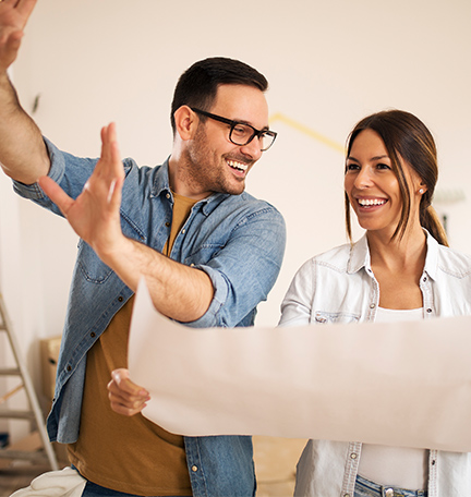 Young couple standing in their apartment, planning a renovation.