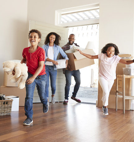 young family moving boxes into their new home
