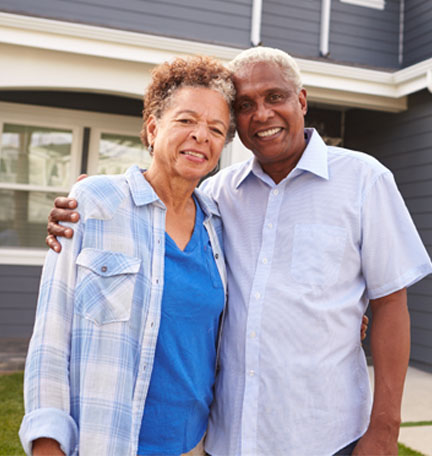 couple in front of new home