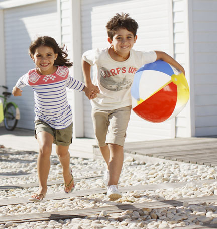 young family getting out of their car at their beach home