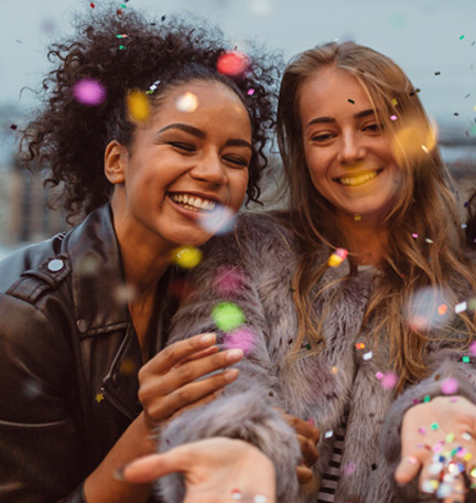 two girls celebrating with confetti