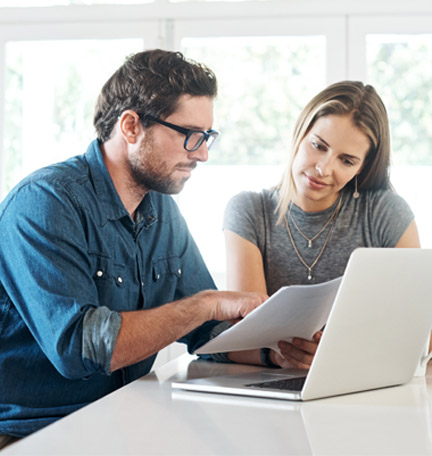 Young couple working on their finances together at home